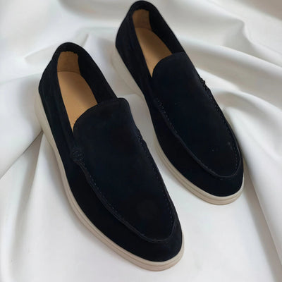 Black Suede Men's Dress Loafers placed on a hardwood floor, shown in gray color, size 48.