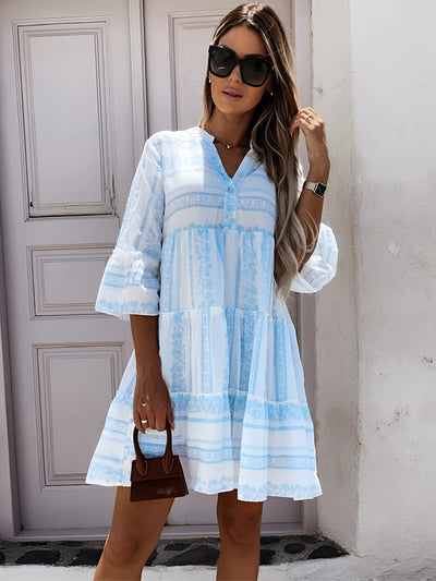 Woman wearing a Green & White Geometric Flowy Summer Dress with Collar in a Casual Mediterranean Style, showcasing shoulder, neck, and leg areas.