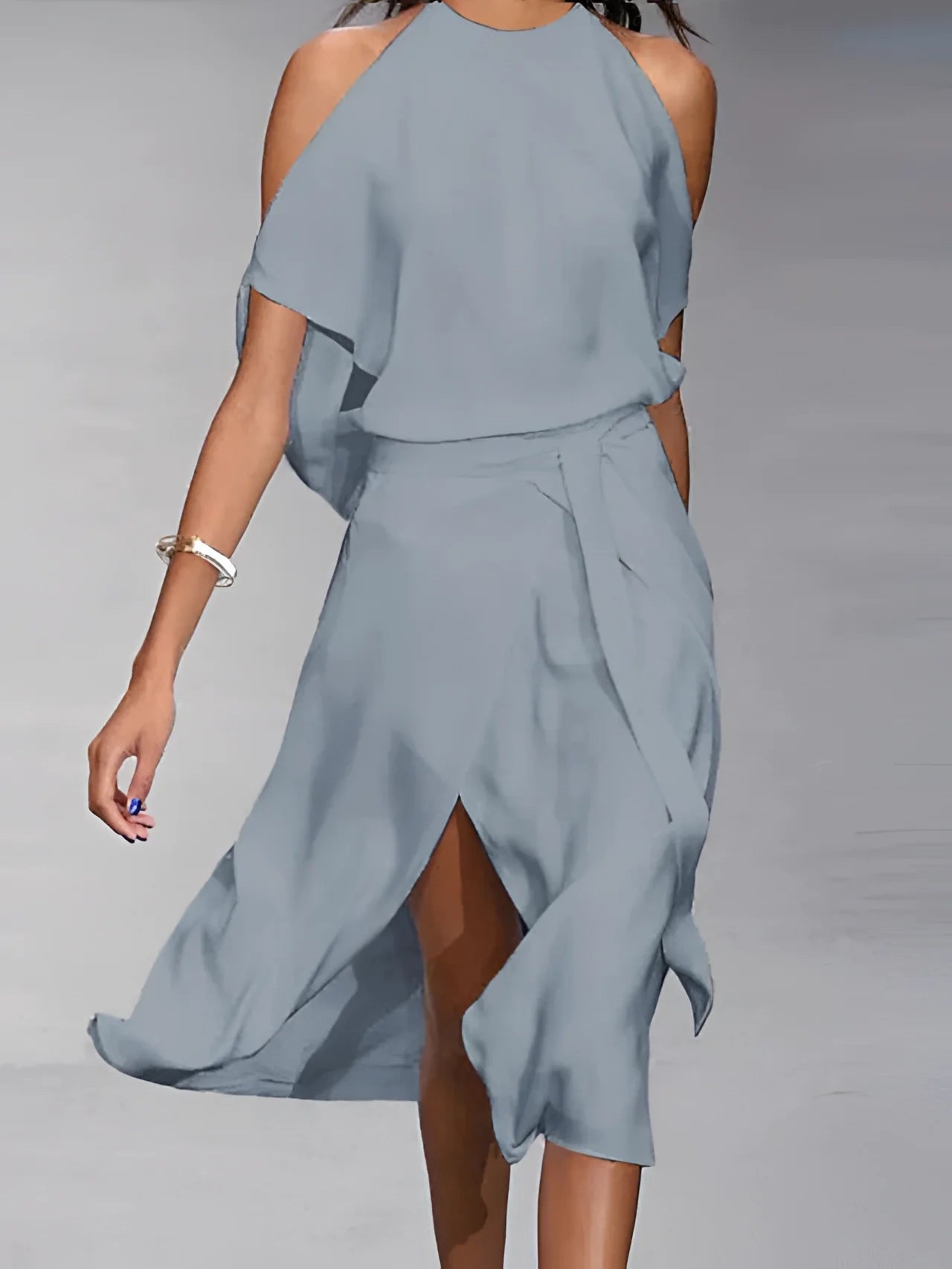 Light blue asymmetrical cold-shoulder midi dress with elegant design, featuring exposed shoulders and mid-length sleeves, styled for a summer cocktail event.