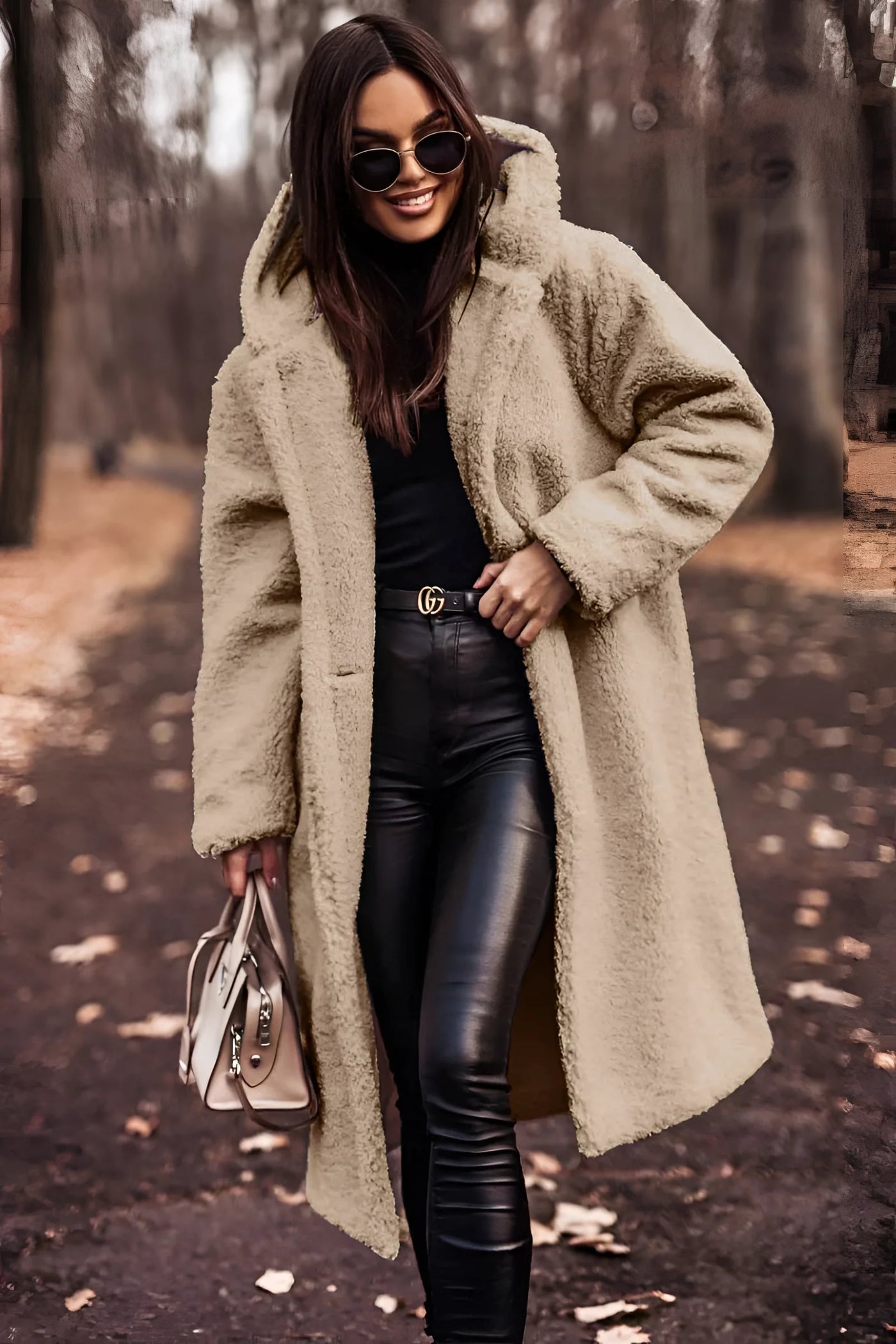 Woman wearing a long, beige, oversized faux fur winter coat, labeled as XL, standing and posing; the coat features full sleeves and a high neck, with a stylish and cozy appearance.