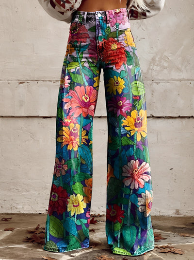 A pair of high-waisted, wide-leg bell-bottom jeans featuring a vibrant floral print with daisies, shown in size 5XL.